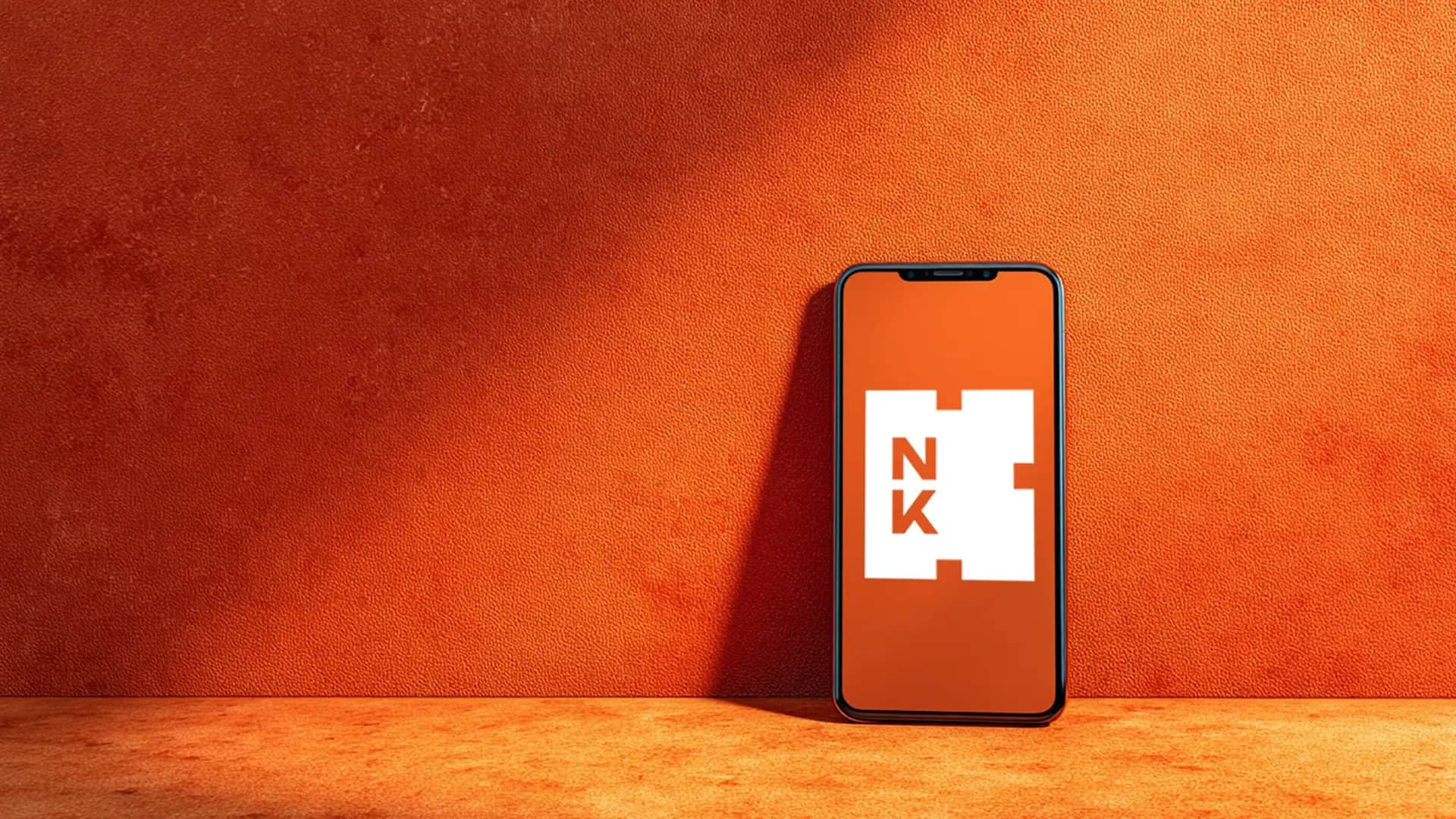 smartphone_on_orange_background.webp